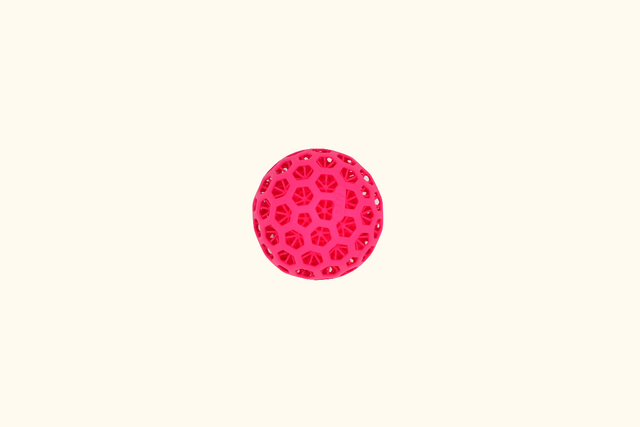 Pink circular ball with a pattern on a white background